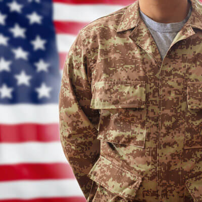 soldier standing in front of american flag